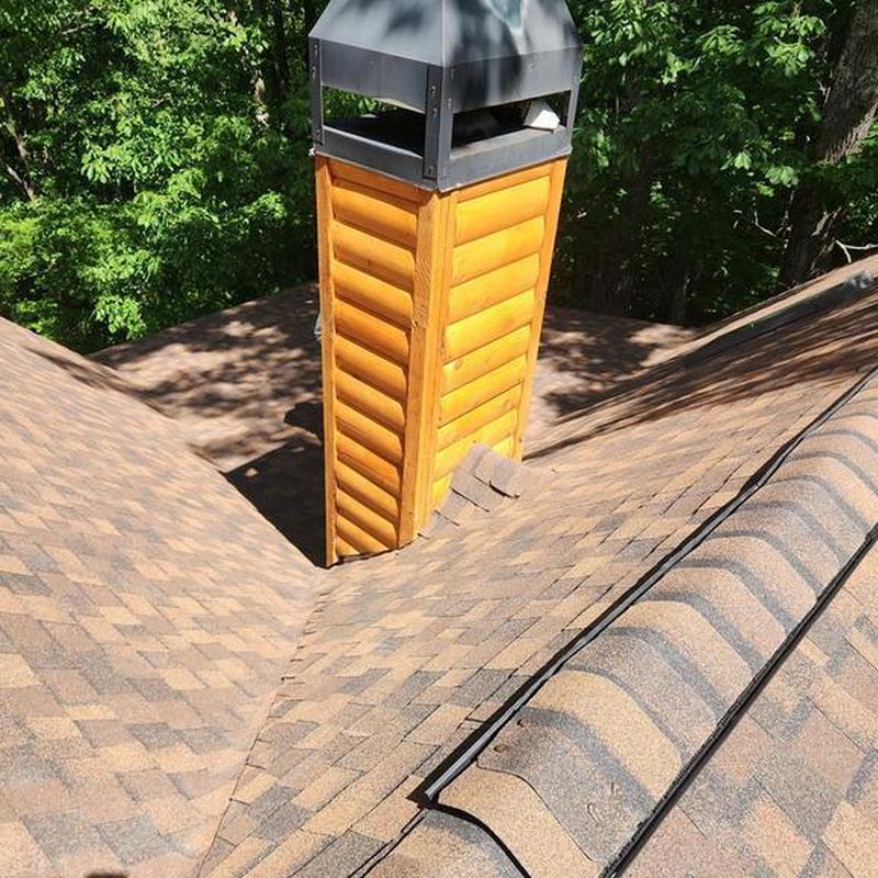 Chimney with new cap and architectural shingles on roof