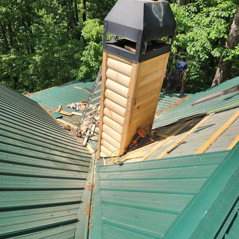 Wood chimney siding installation on metal roof