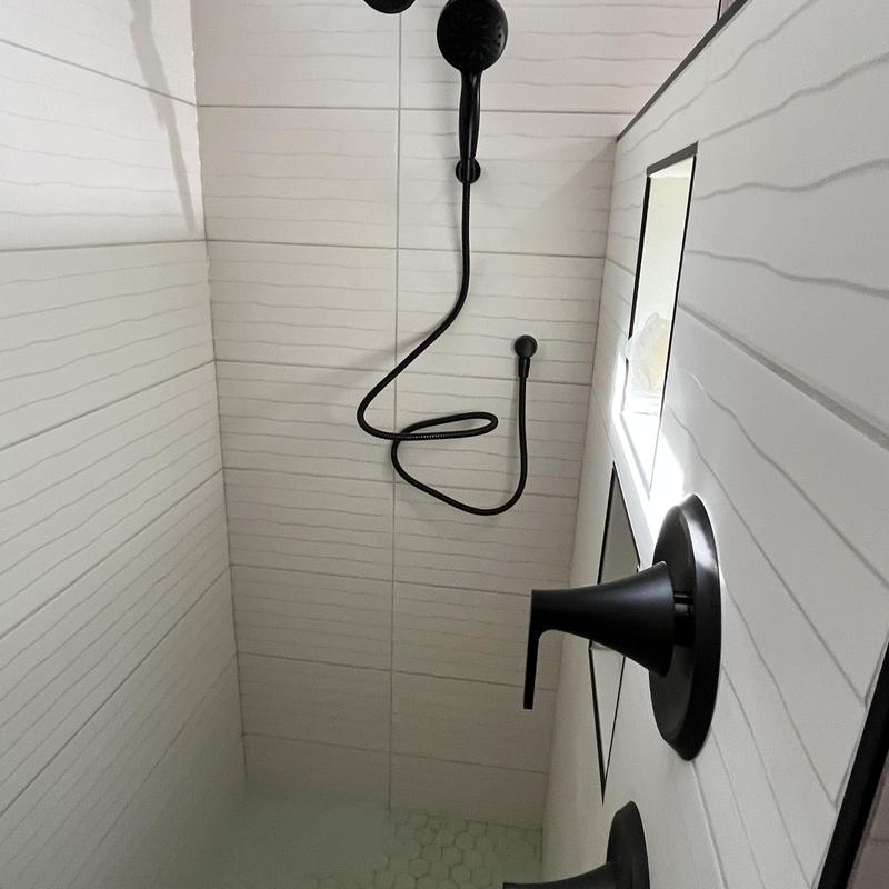 Walk-in shower trim and drain connection with black fixtures Walk-in shower trim and drain connection with black fixtures