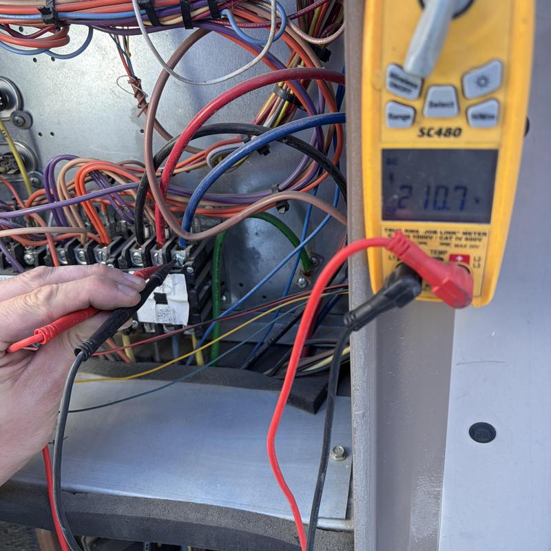 HVAC transformer voltage testing with multimeter probe