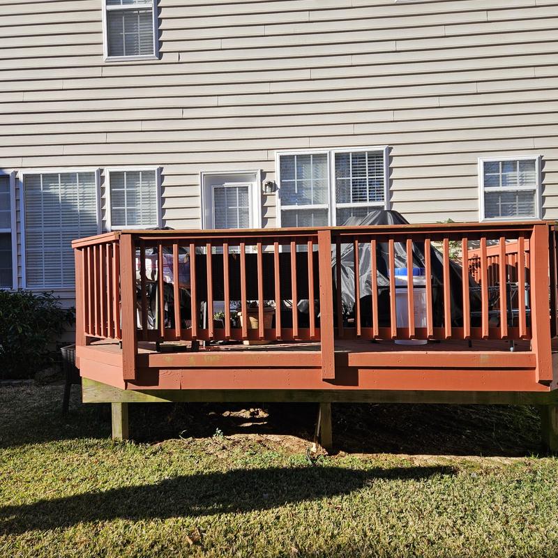 Wooden residential deck with railing in backyard Wooden residential deck with railing in backyard