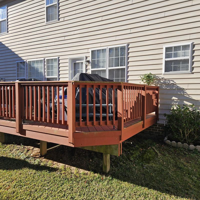 Wood deck with railing attached to house exterior Wood deck with railing attached to house exterior