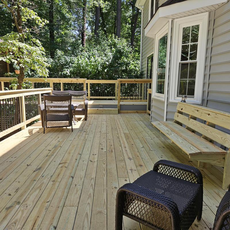 Wooden deck with built-in bench and chairs Wooden deck with built-in bench and chairs