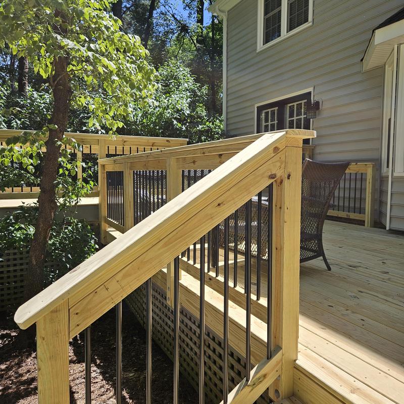 Wooden deck railing with black metal balusters Wooden deck railing with black metal balusters