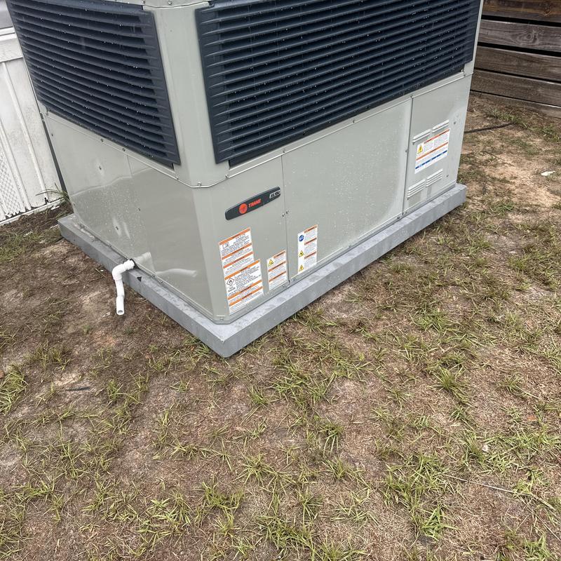 Trane air conditioning unit on concrete pad outdoors Trane air conditioning unit on concrete pad outdoors