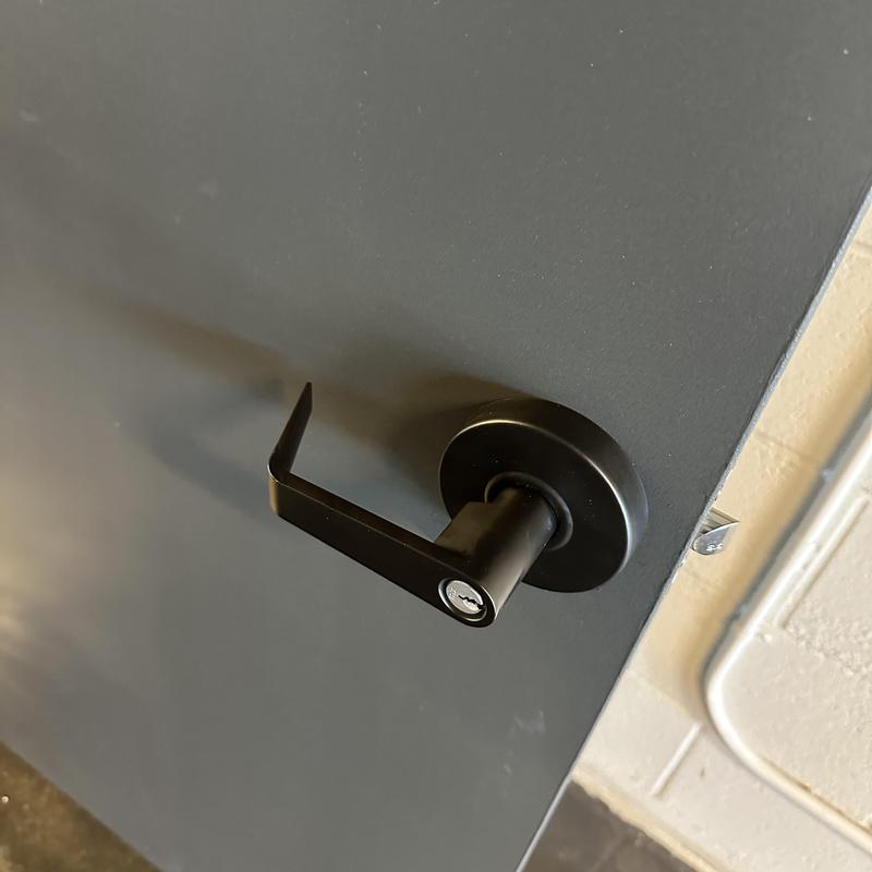 Commercial door lock with black lever handle
