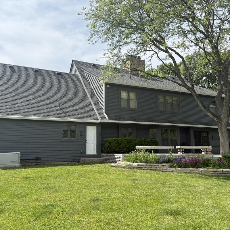 Atlas impact class 4 roof on two-story house with landscaping Atlas impact class 4 roof on two-story house with landscaping
