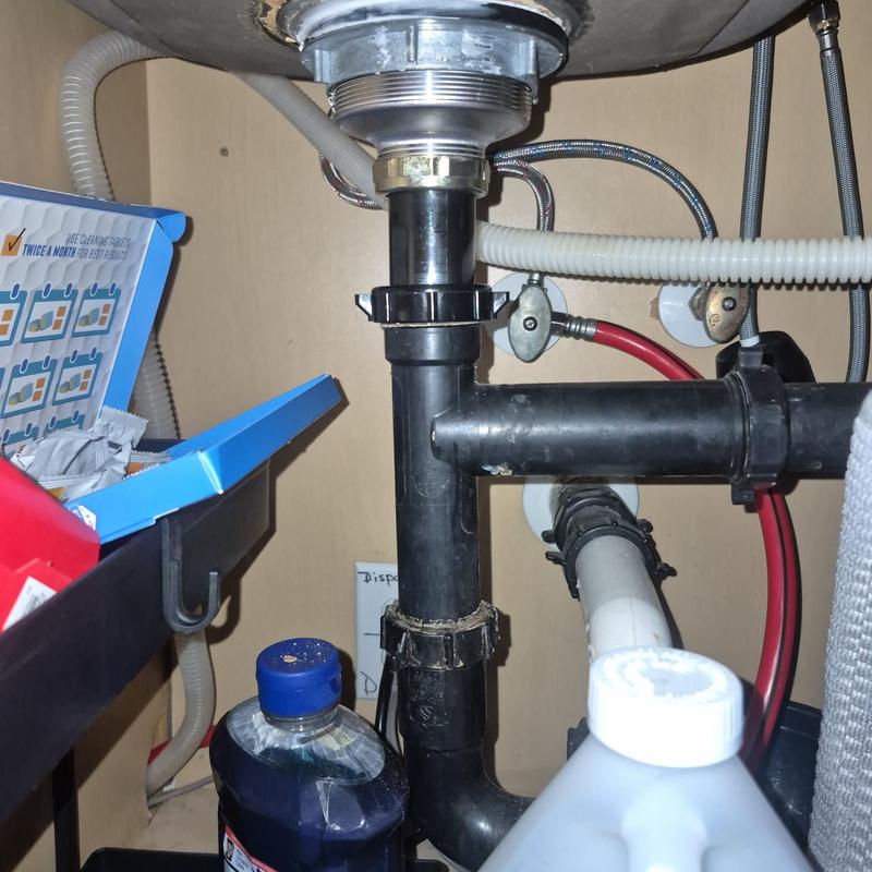 Basket strainer and sink drain plumbing under cabinet