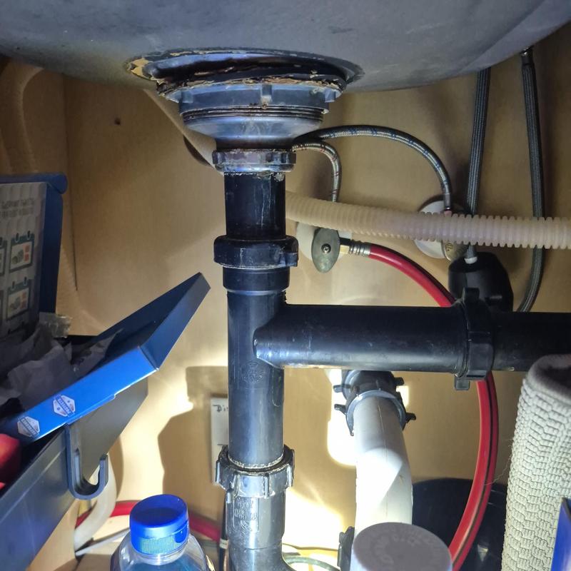 Basket strainer under sink plumbing with drain pipes