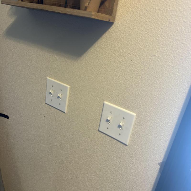 Toggle light switches installed on interior wall