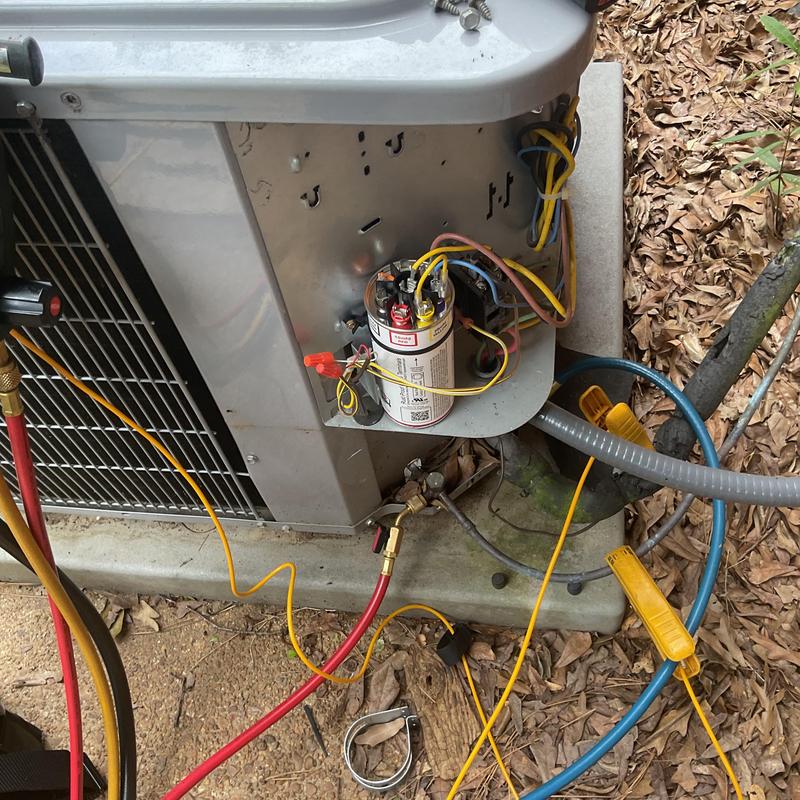 AC capacitor with connected wiring and gauges outdoors AC capacitor with connected wiring and gauges outdoors