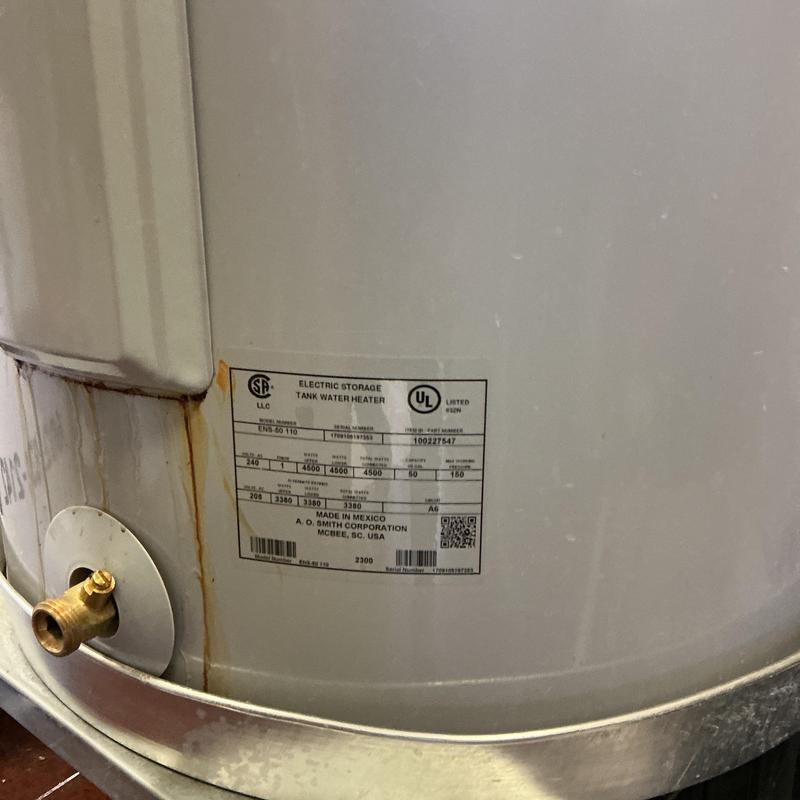 Electric storage tank water heater with rust spots