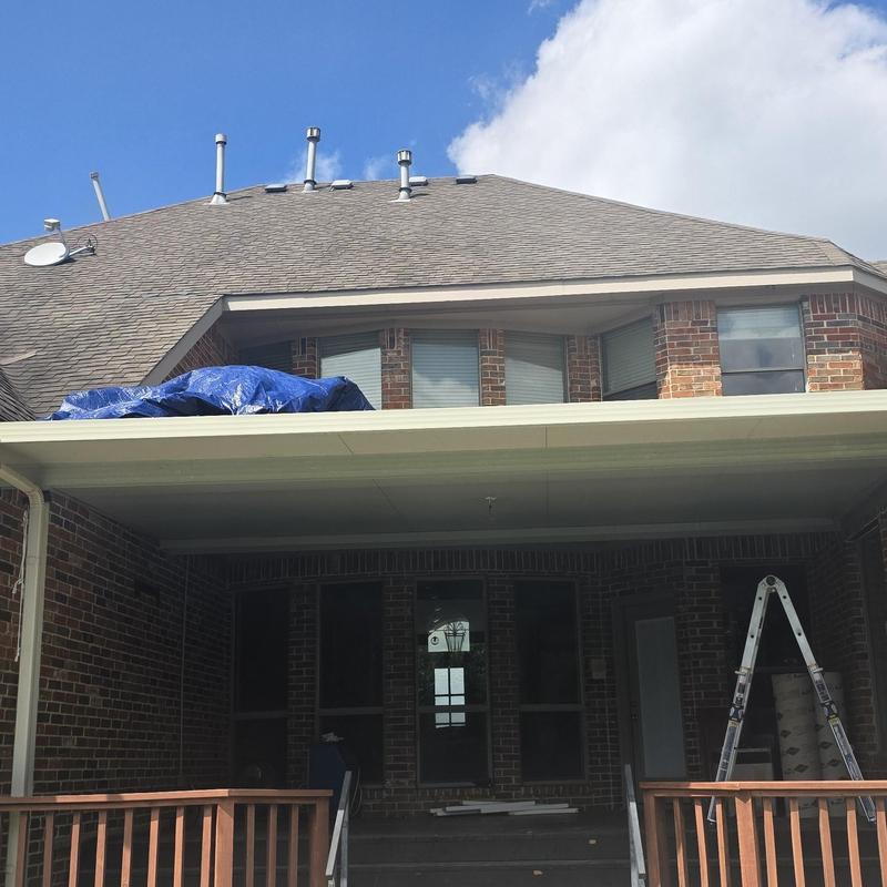 Asphalt shingle roof with hail damage and tarp cover
