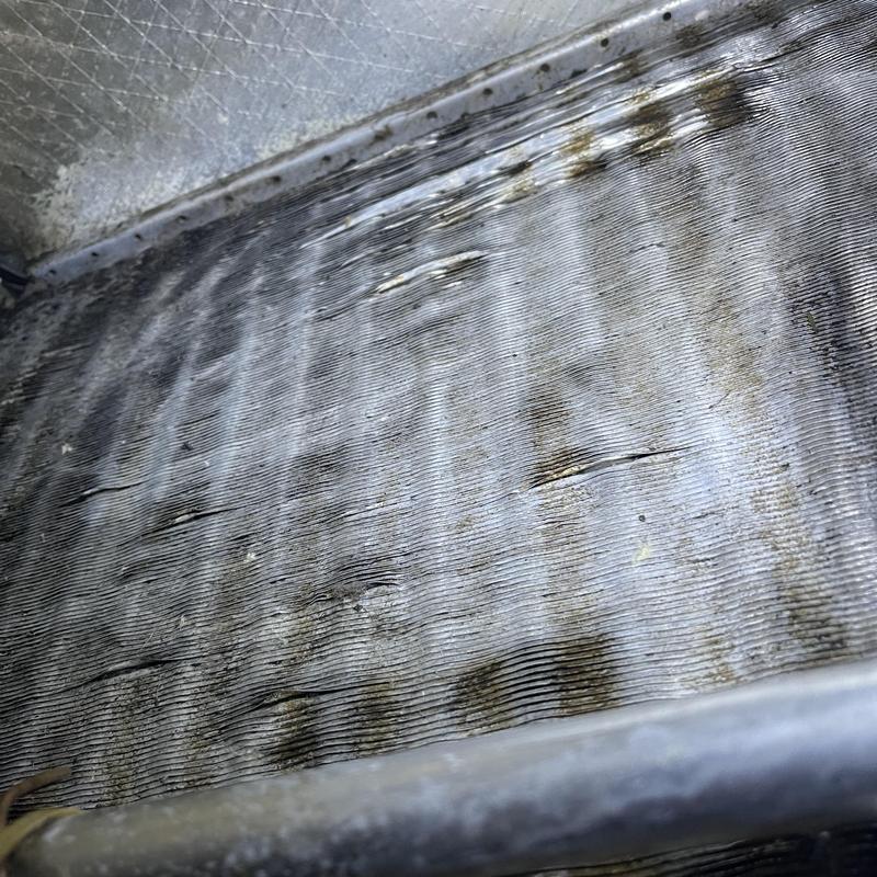 Evaporator coil with bent fins inside air handler Evaporator coil with bent fins inside air handler