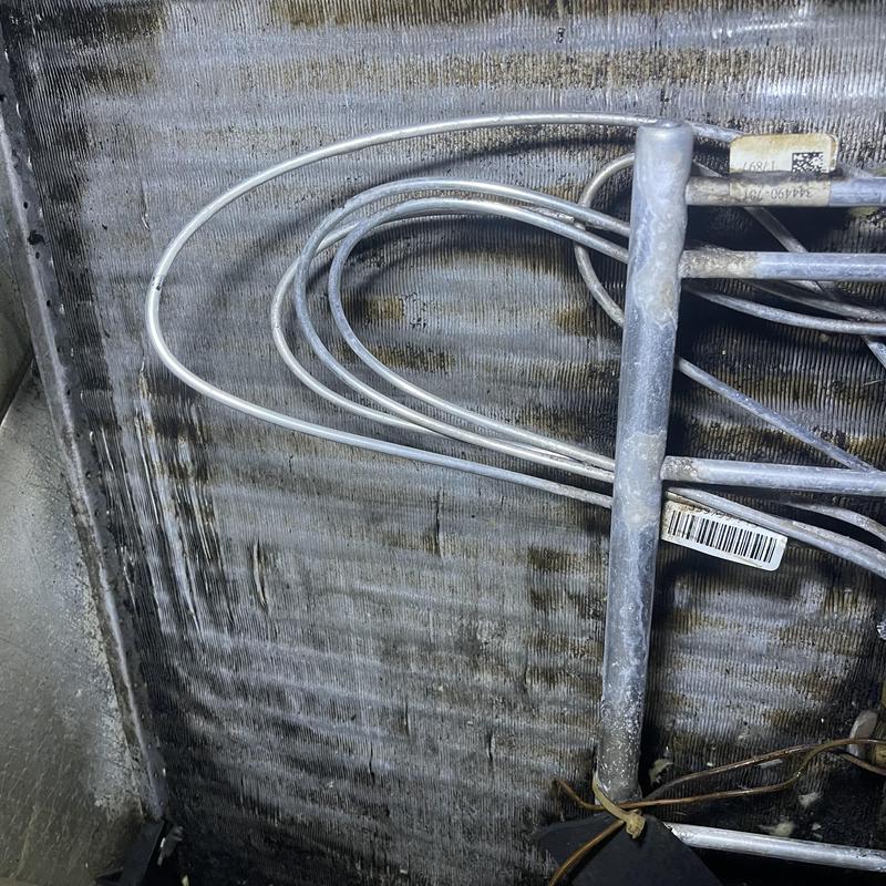 Evaporator coil with bent fins and tubing in air handler Evaporator coil with bent fins and tubing in air handler