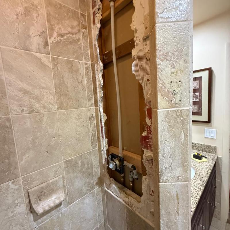 Shower valve installation with exposed plumbing wall