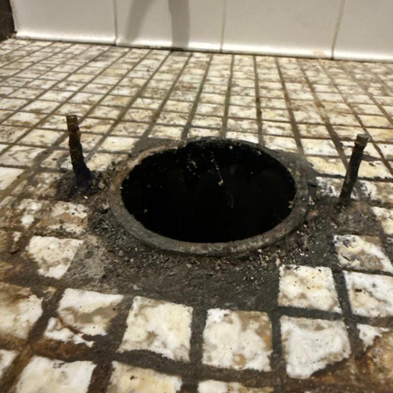 Toilet flange on tiled bathroom floor, removed toilet