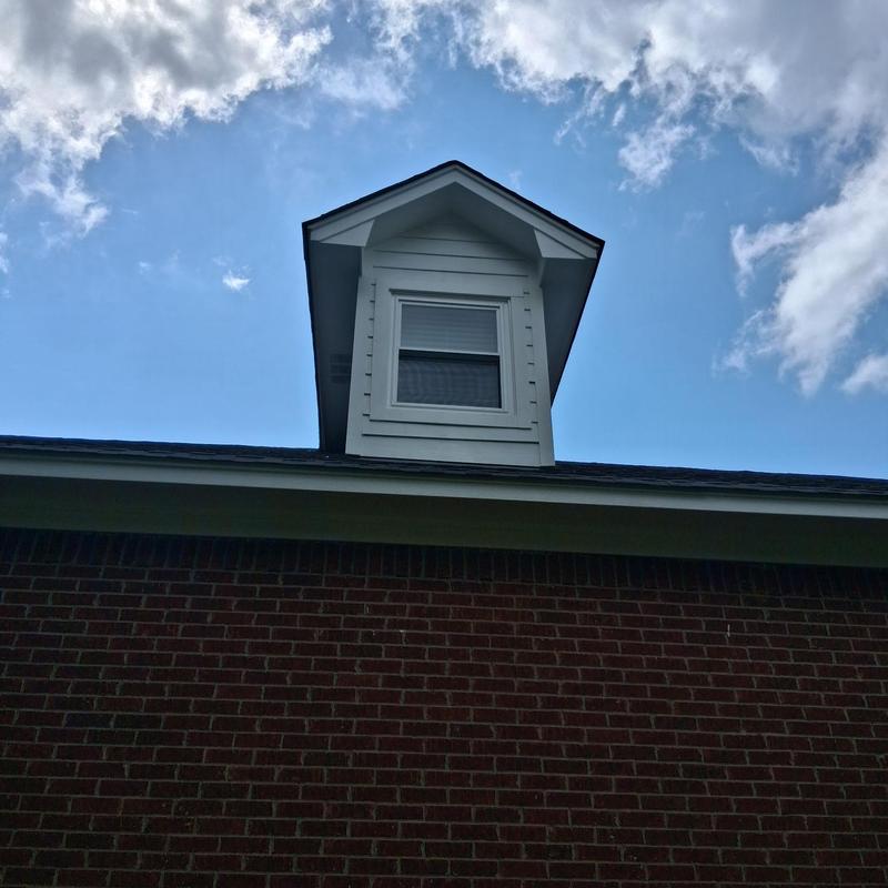 Dormer window with insulated glass on brick house