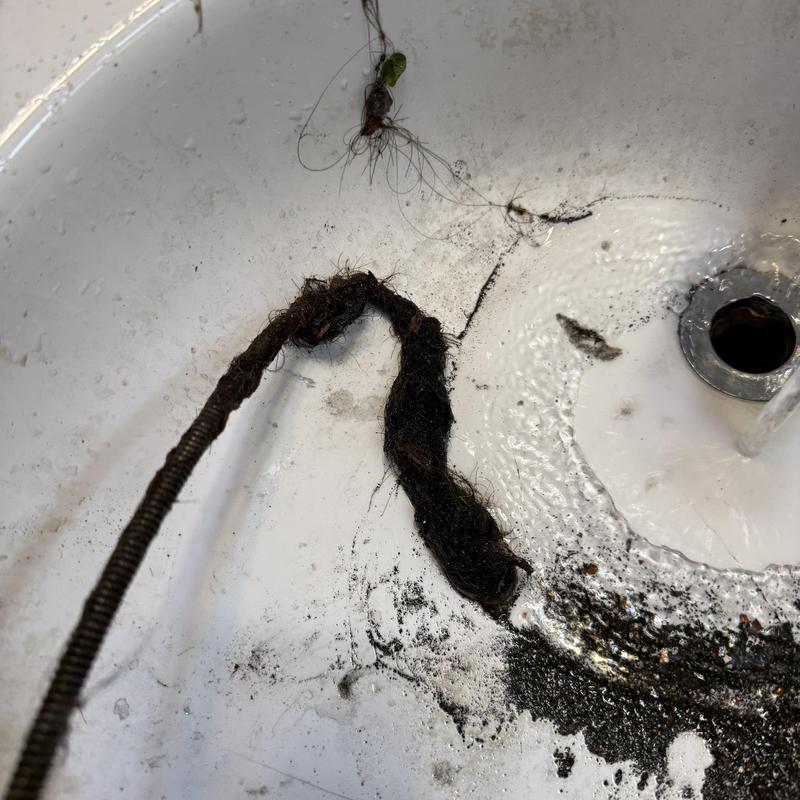 Basin drain clog with hair removal and snaking tool Basin drain clog with hair removal and snaking tool