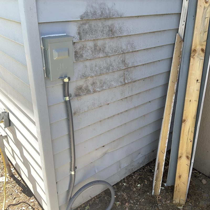 Electrical disconnect box and conduit on siding exterior