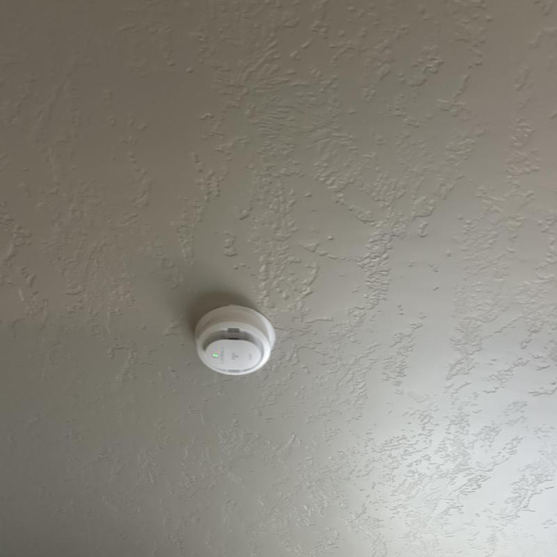 Hardwired smoke and carbon monoxide detector on ceiling