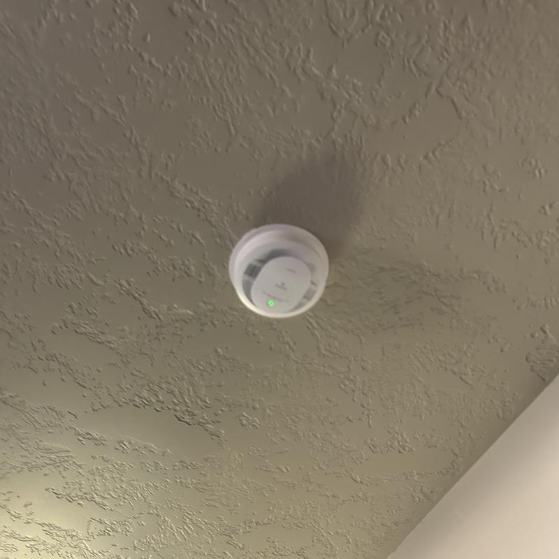 Hardwired smoke detector with battery backup on ceiling