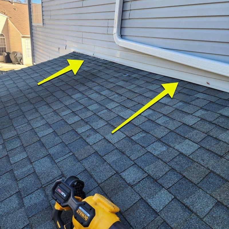 Sunroom roof shingles with leak damage arrows
