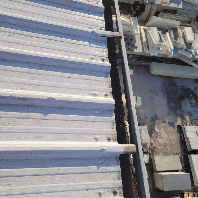 Metal roof panel with damaged fasteners and sealant breakdown Metal roof panel with damaged fasteners and sealant breakdown