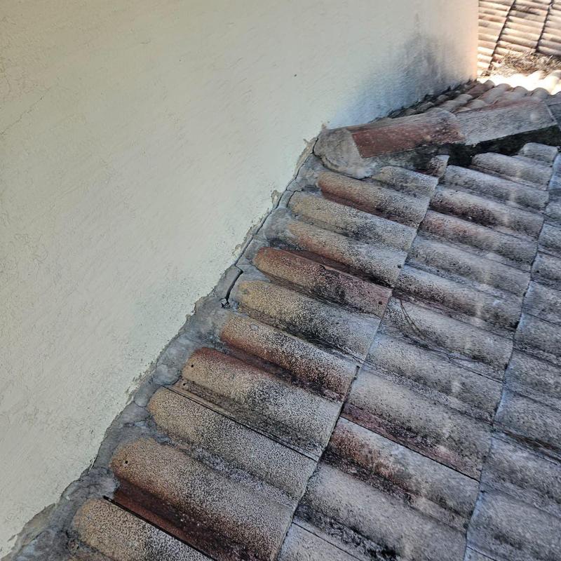 Concrete tile roof with cracked and damaged flashing Concrete tile roof with cracked and damaged flashing