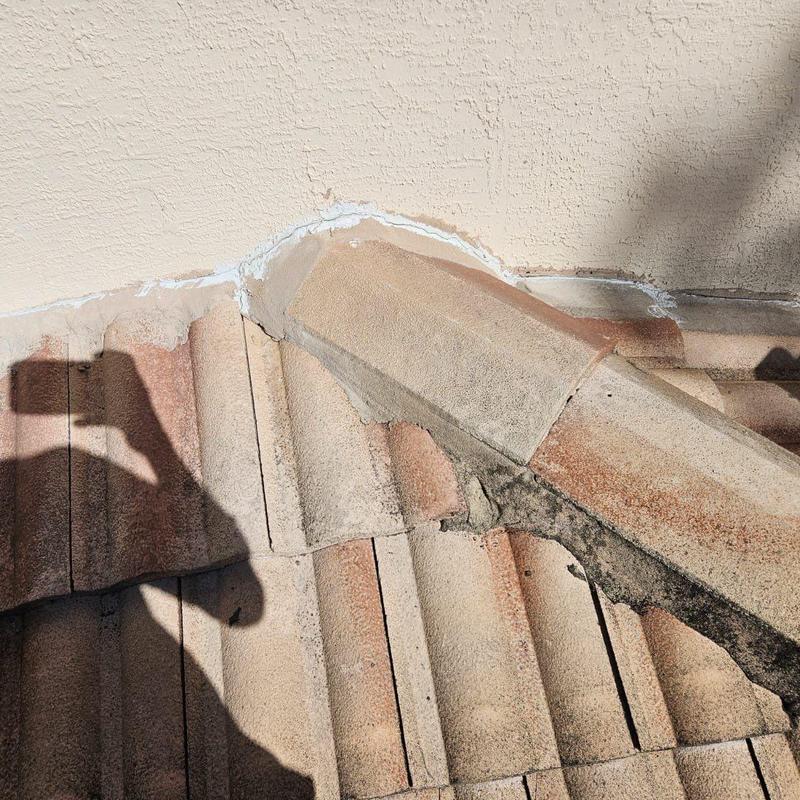 Concrete tile roofing with damaged flashing and mortar Concrete tile roofing with damaged flashing and mortar
