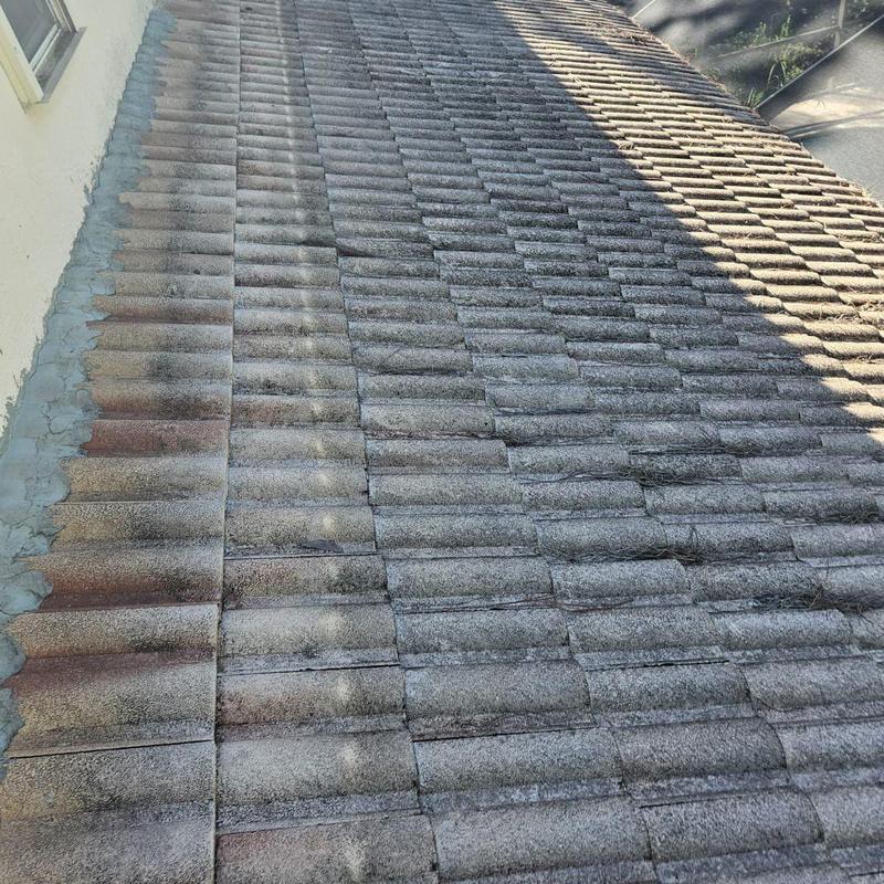 Concrete tile roof with weathered and damaged tiles Concrete tile roof with weathered and damaged tiles