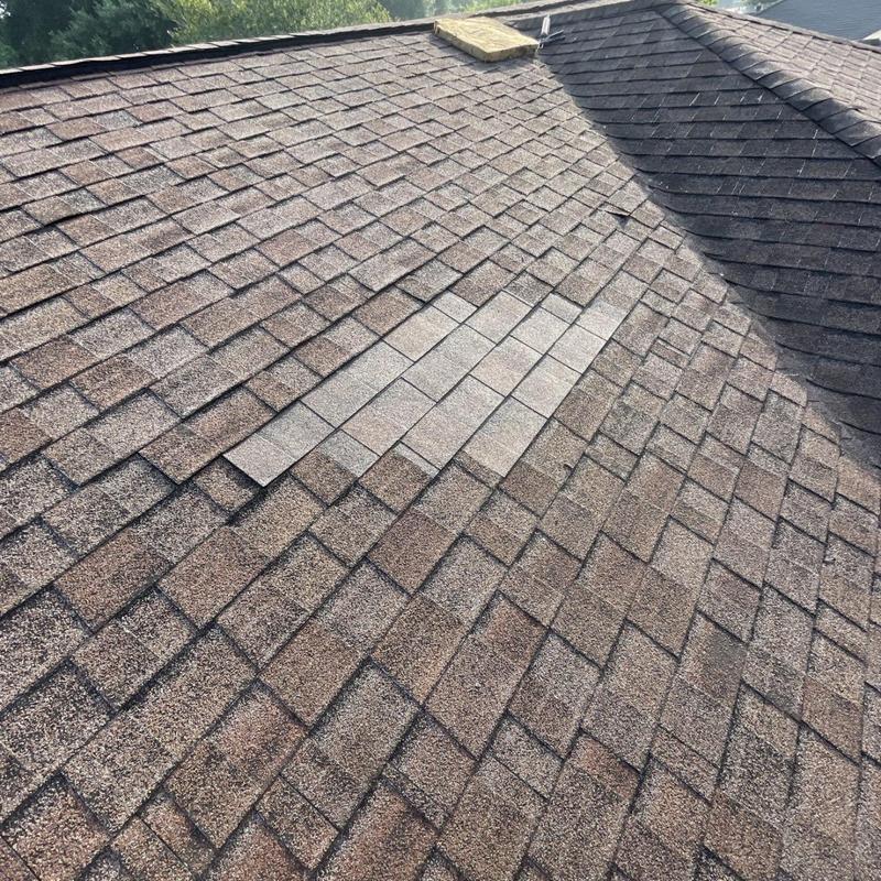 Asphalt shingle patch repair on residential roof