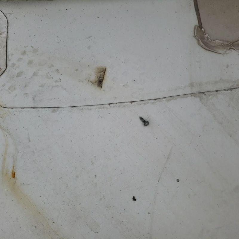 TPO flat roof with damaged seam and loose screw TPO flat roof with damaged seam and loose screw