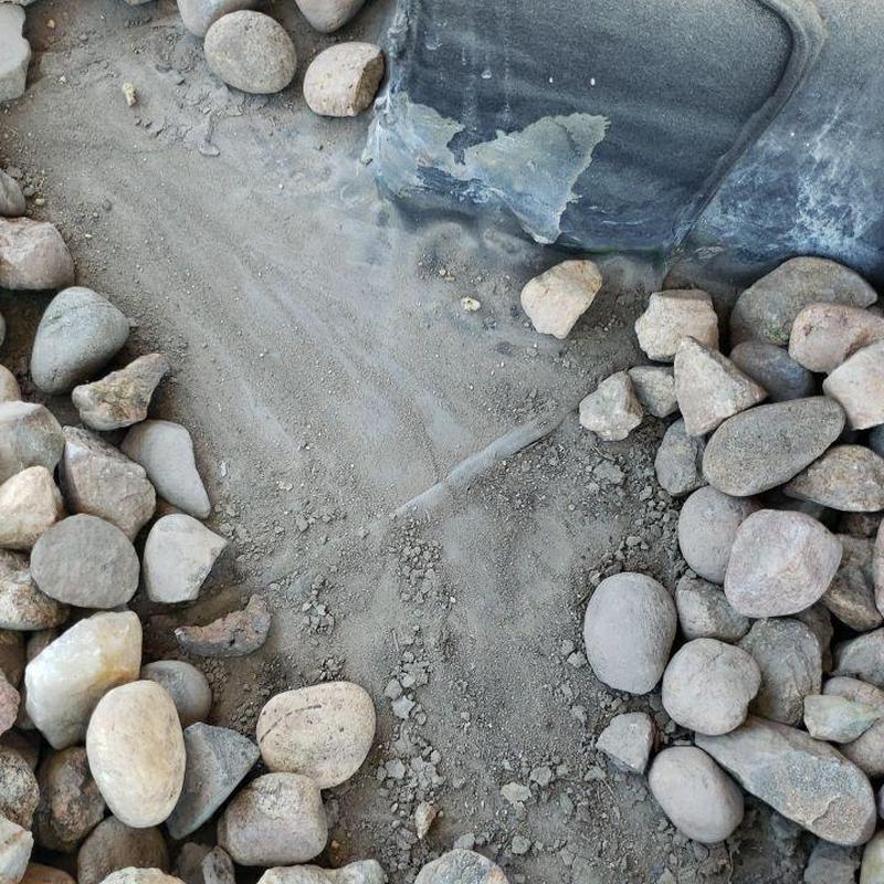 EPDM roof damaged corners and holes with surrounding rocks EPDM roof damaged corners and holes with surrounding rocks