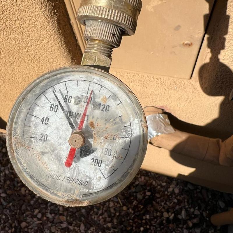 Pressure gauge on water main with taped pipe joint