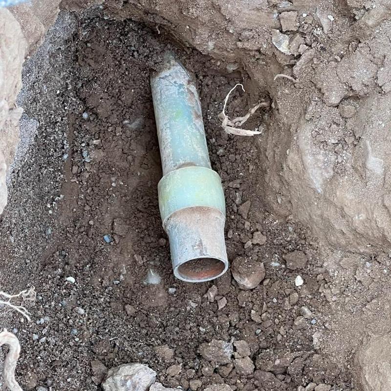 Copper pipe and PEX adapter in excavation trench