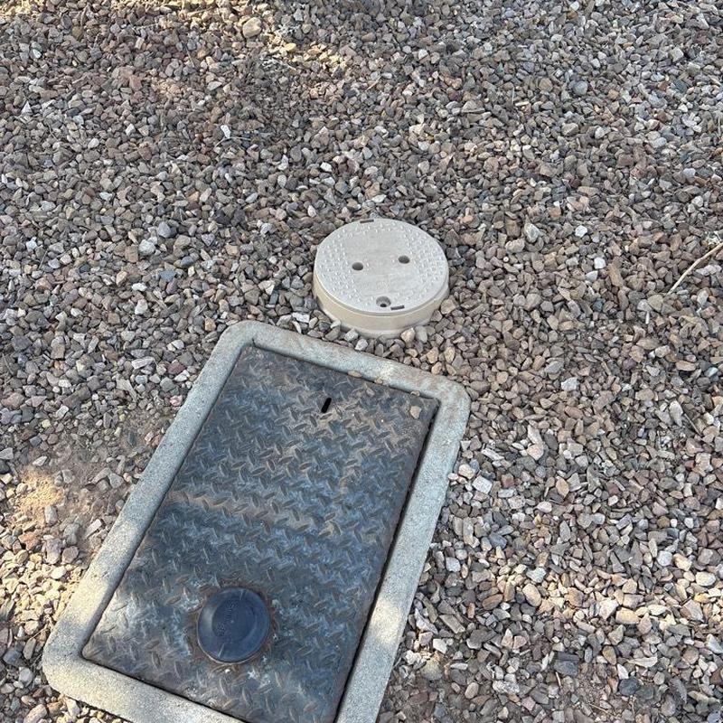 1-inch P.R.V. with tan access box by water meter
