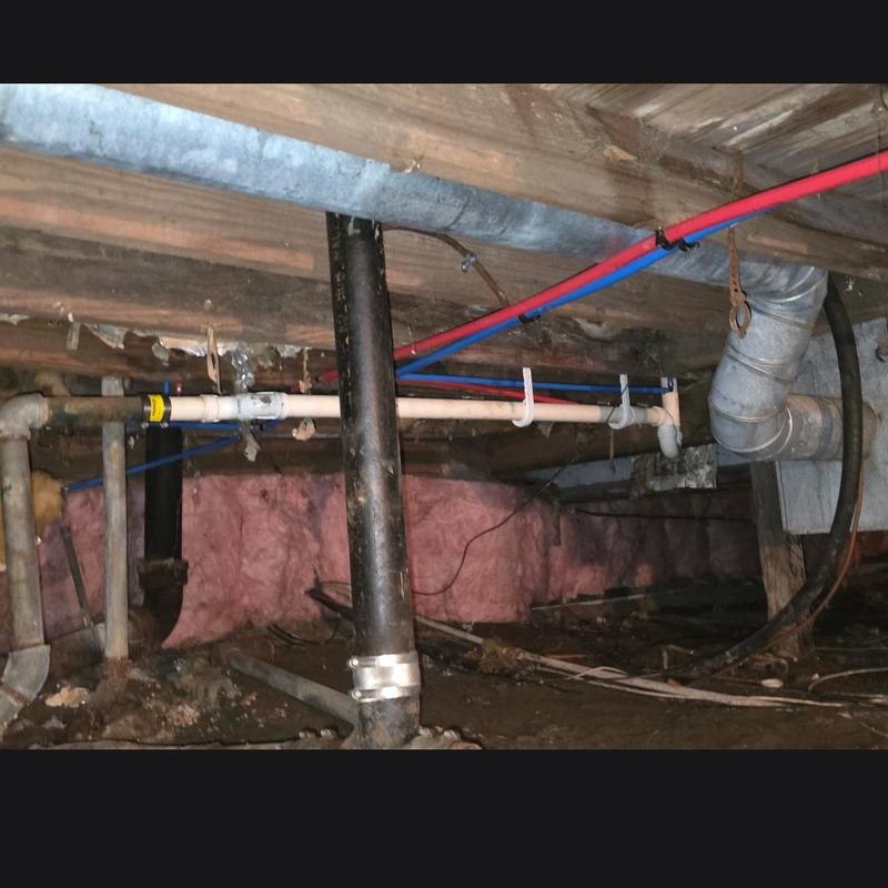 Water line and trip waste overflow installation in crawlspace