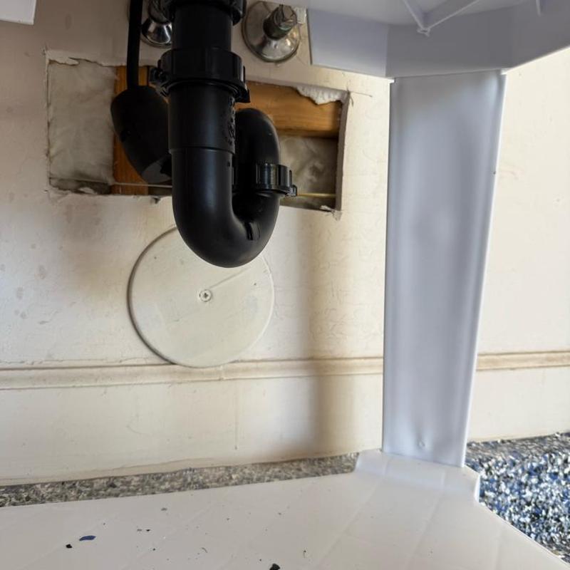 Utility sink drain pipe with drywall access hole