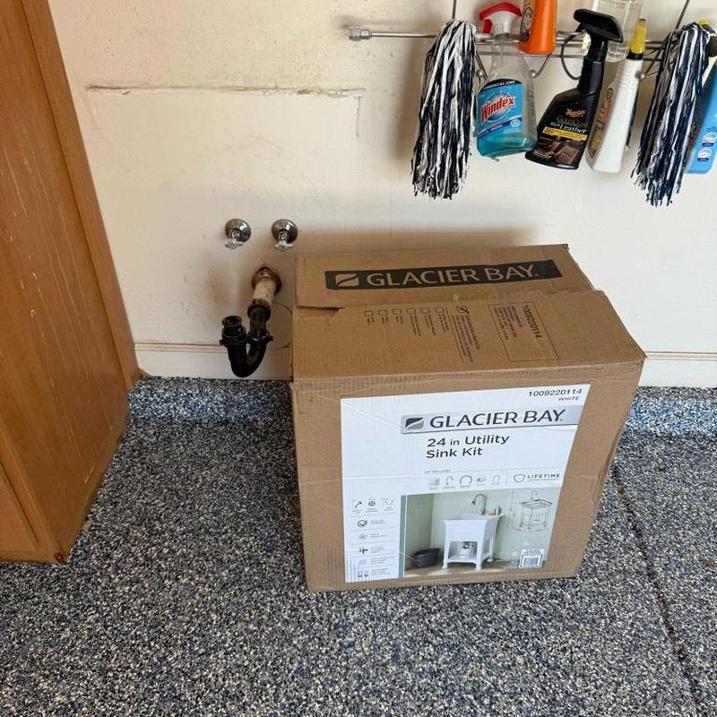 Utility sink plumbing with installed drain and water lines