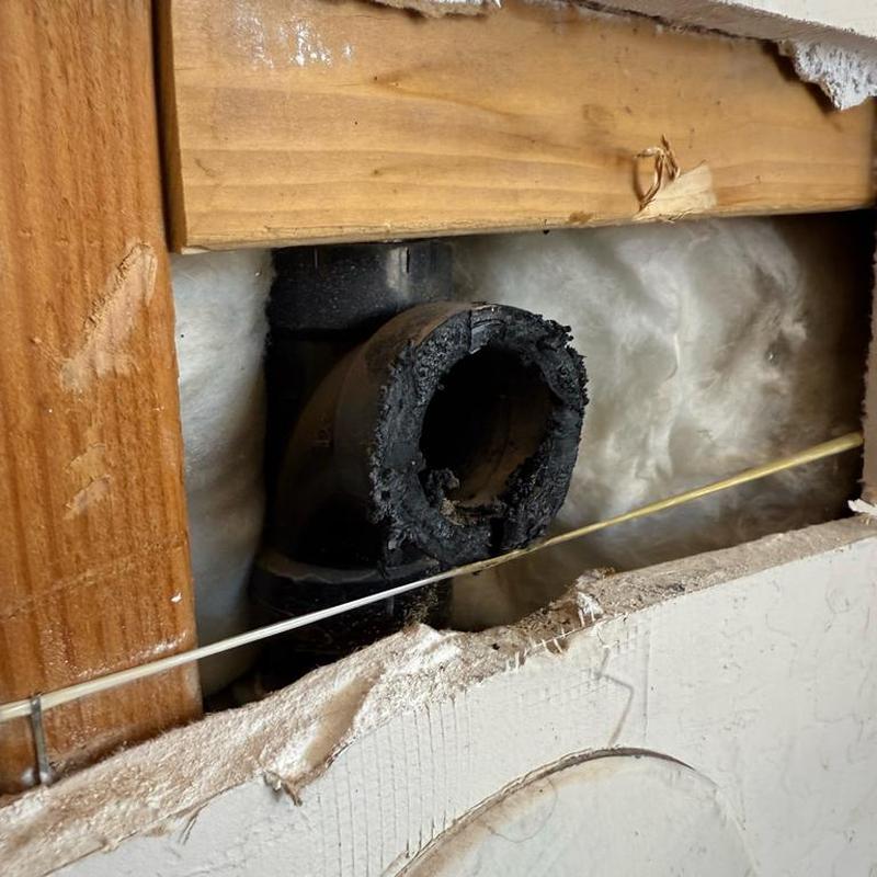 ABS drain pipe with damaged fitting in wall cavity