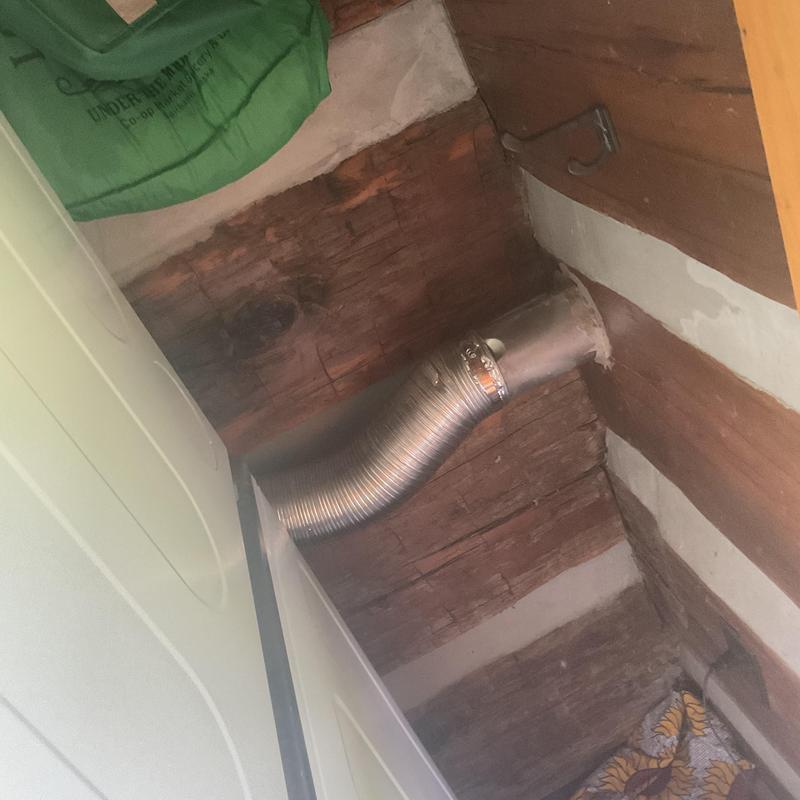 Dryer vent duct with metal clamp in laundry area Dryer vent duct with metal clamp in laundry area