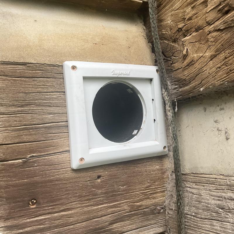 Dryer vent outlet on exterior wooden wall Dryer vent outlet on exterior wooden wall