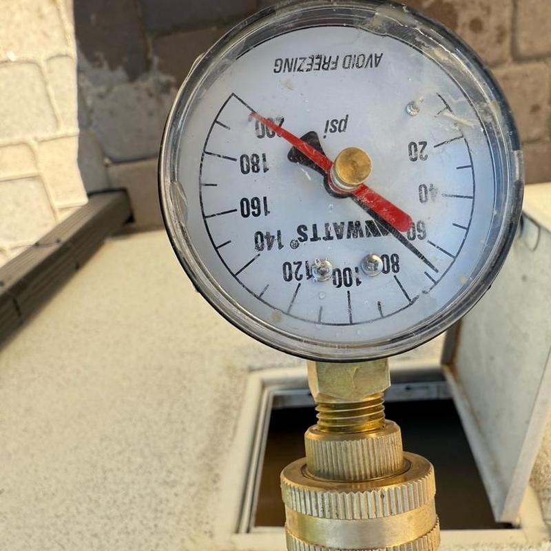 Pressure gauge on plumbing system measuring PSI