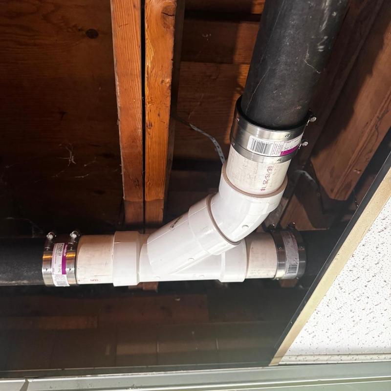 Cast iron to PVC wye fitting transition with clamps