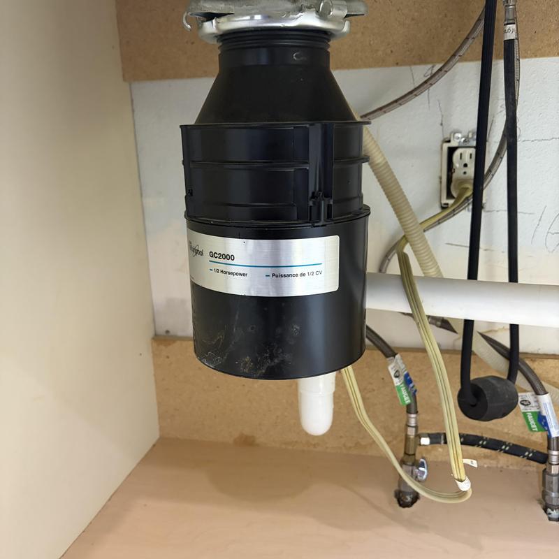 Garbage disposal appliance under kitchen sink installation