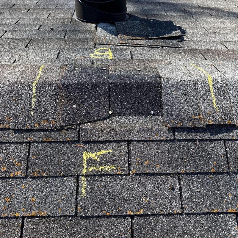 Roof shingles with hail damage and chalk markings