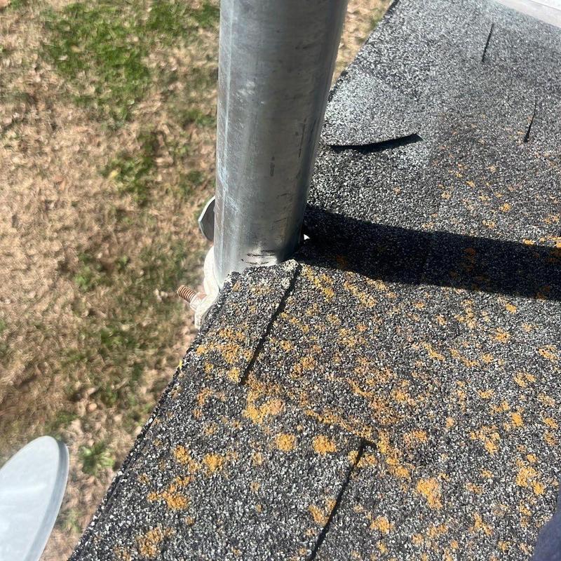 Asphalt shingles with hail damage near pipe flashing