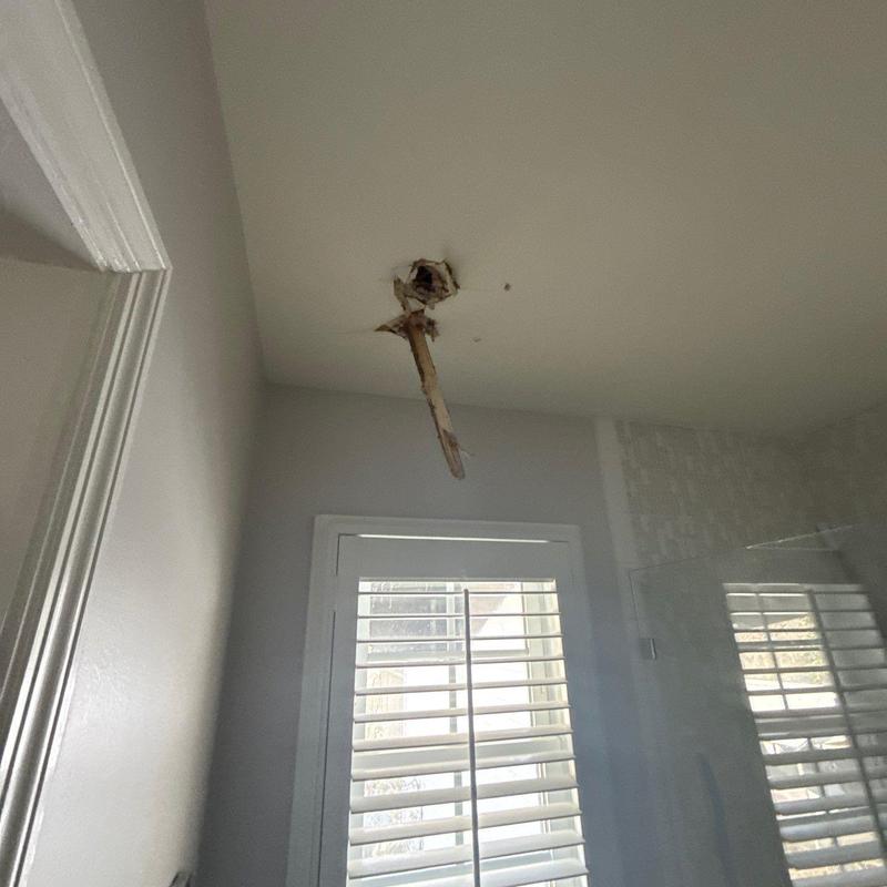 Ceiling drywall with water damage and broken wood beam