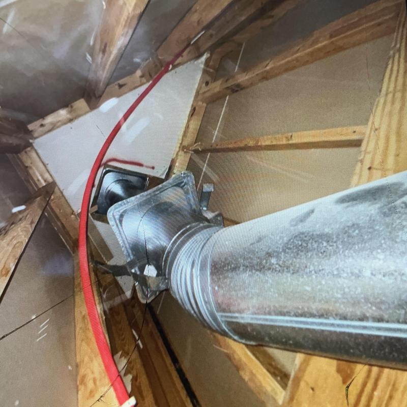 Three-quarter red PEX hotline rerouted overhead in attic